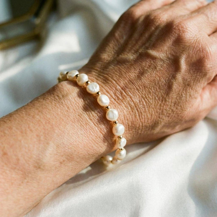Retro white bracelet with pearls and gold accents