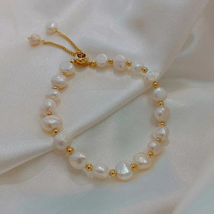 Retro white bracelet with pearls and gold accents